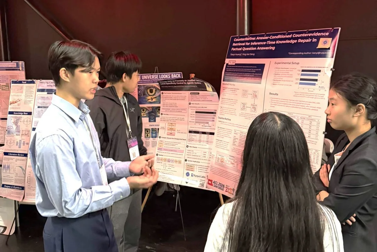 Students discussing a research poster with visitors at a poster session.